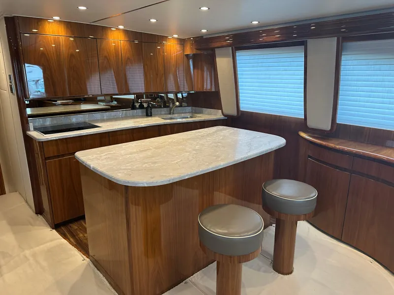 Slide: The Image of Luxurious interior of 2017 Viking 55 Convertible yacht with modern kitchen and seating. - 7