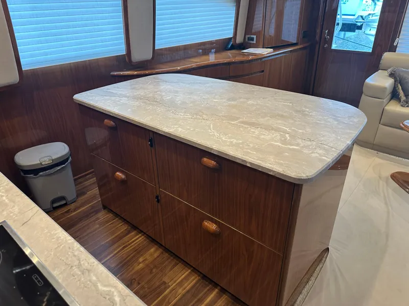 Slide: The Image of Interior of 2017 Viking 55 Convertible yacht with elegant wooden cabinetry and marble countertop. - 8