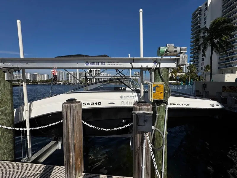 The Image of 2011 Yamaha SX240 HO boat docked at marina with cityscape background. - 0