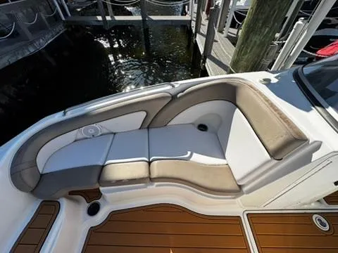 Slide: The Image of 2011 Yamaha Boats SX240 HO interior seating with cushioned lounge area and teak-style flooring. - 14