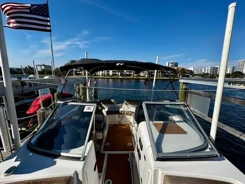 Slide: The Image of 2011 Yamaha Boats SX240 HO docked, with American flag, overlooking a scenic waterfront. - 15
