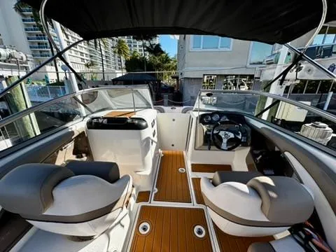 Slide: The Image of 2011 Yamaha Boats SX240 HO interior with dual seating, modern dashboard, and wood-style flooring. - 4