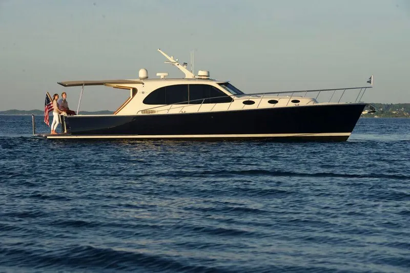 The Image of 2026 Palm Beach Motor Yachts PB42 cruising on calm waters at sunset. - 0