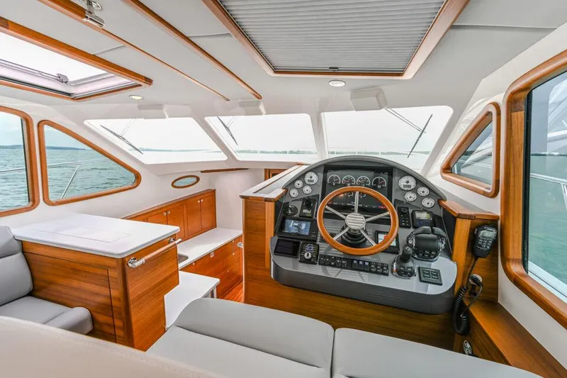 Slide: The Image of Luxurious 2026 Palm Beach Motor Yachts PB42 interior with elegant wood finish and modern controls. - 3