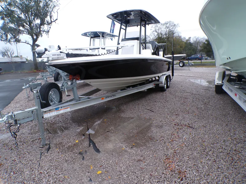 The Image of 2024 ShearWater 250 SS Carolina boat on trailer under cloudy sky. - 0