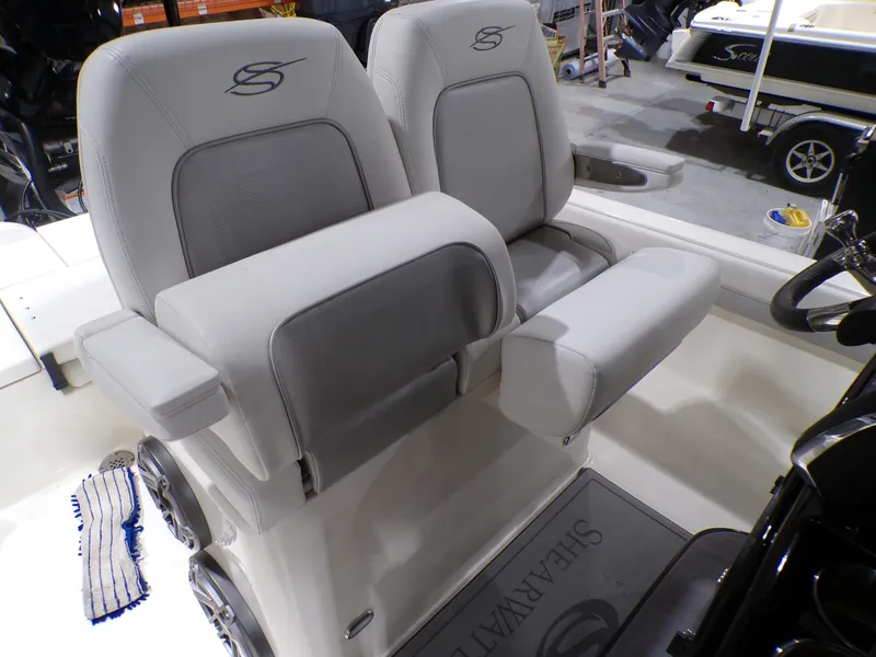 Slide: The Image of 2024 ShearWater 250 SS Carolina boat interior with cup holder and chrome details. - 19