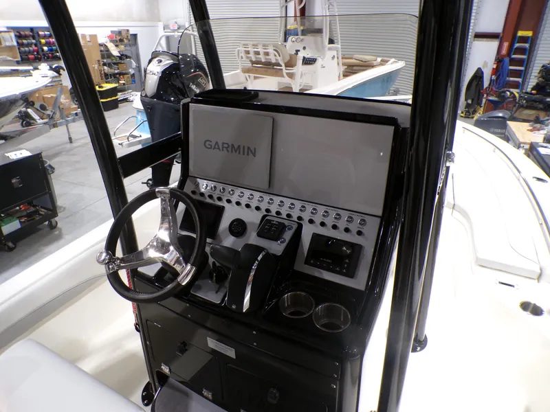 Slide: The Image of 2024 ShearWater 250 SS Carolina boat seats in a showroom setting. - 20