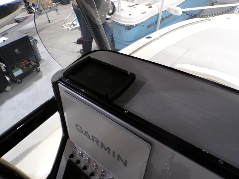 Slide: The Image of 2024 ShearWater 250 SS Carolina boat dashboard with control panel and switches. - 28