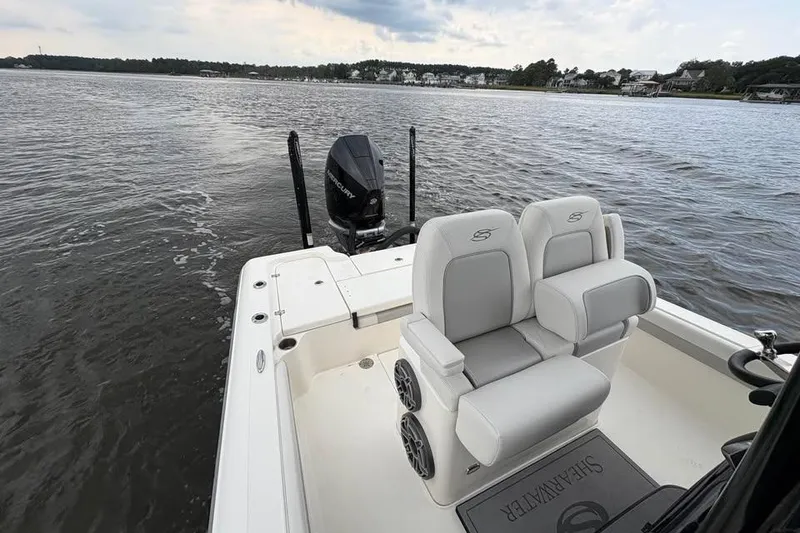 Slide: The Image of 2024 ShearWater 250 SS Carolina boat on calm water, featuring comfortable seating. - 36