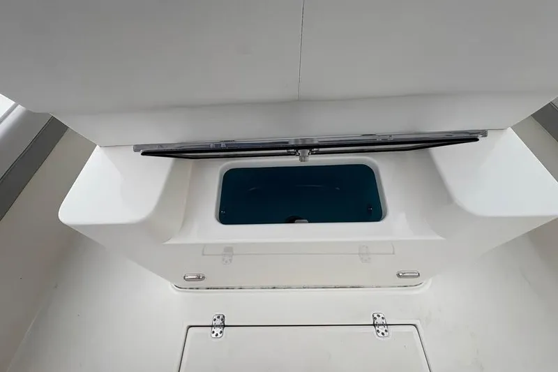 Slide: The Image of 2024 ShearWater 250 SS Carolina boat interior with storage compartment. - 39