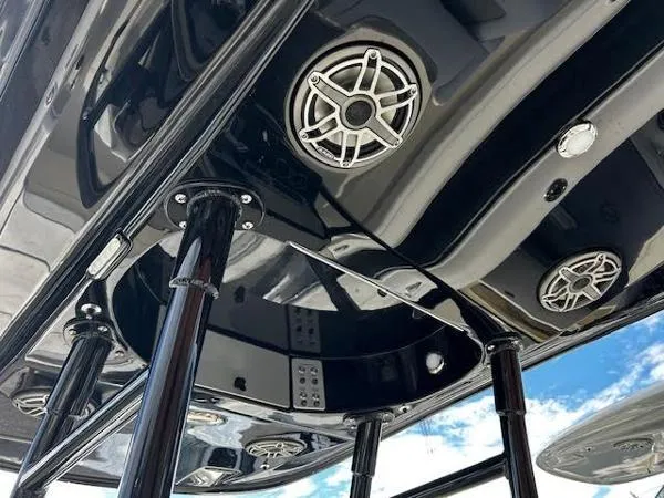 Slide: The Image of 2024 ShearWater 250 SS Carolina boat on trailer, parked near trees under cloudy sky. - 4