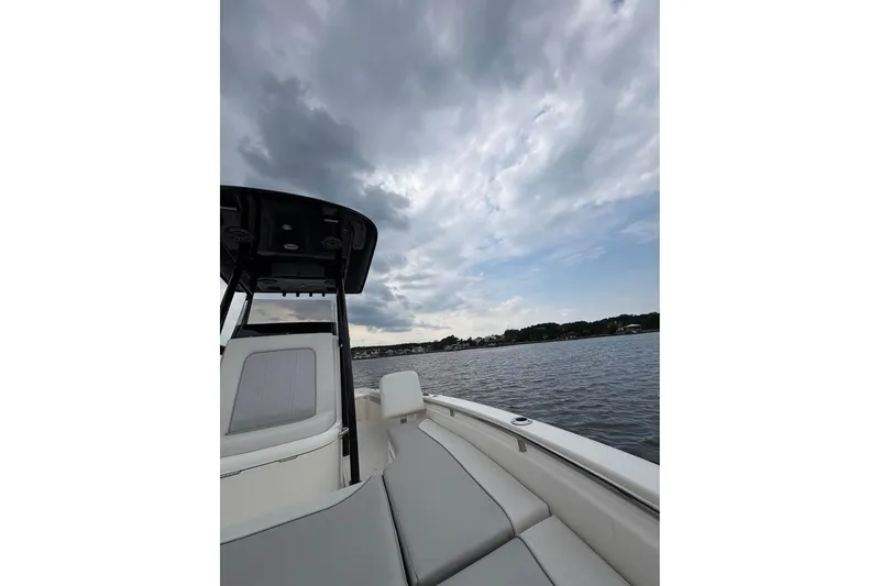 Slide: The Image of 2024 ShearWater 250 SS Carolina boat on calm water under cloudy sky. - 42