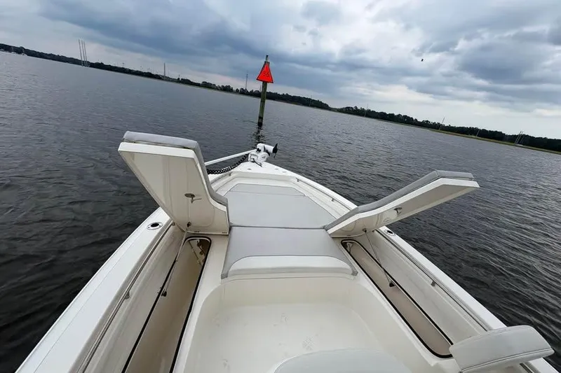 Slide: The Image of 2024 ShearWater 250 SS Carolina boat on calm water, open storage compartments. - 45