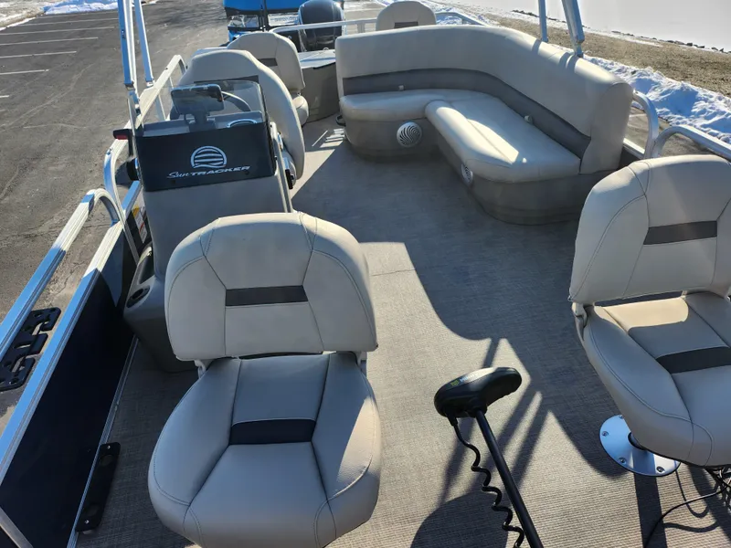 Slide: The Image of 2023 Sun Tracker Bass Buggy 18 DLX pontoon boat interior with seating and steering console. - 11