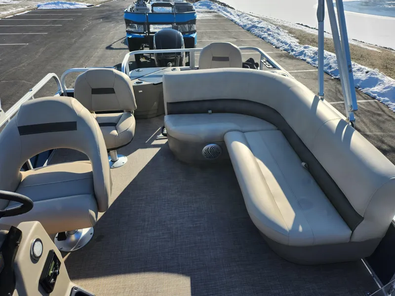 Slide: The Image of 2023 Sun Tracker Bass Buggy 18 DLX pontoon boat interior with beige seating. - 13