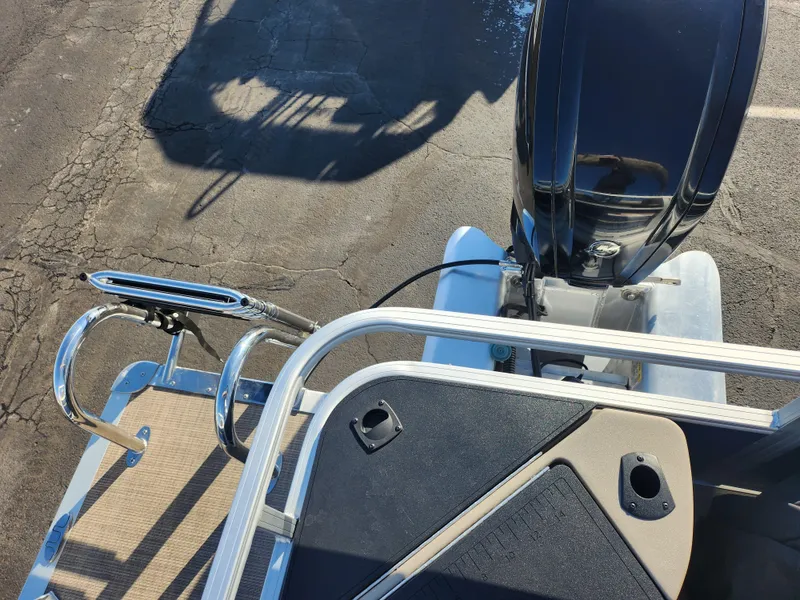 Slide: The Image of 2023 Sun Tracker Bass Buggy 18 DLX boat, rear view with motor and deck details. - 15