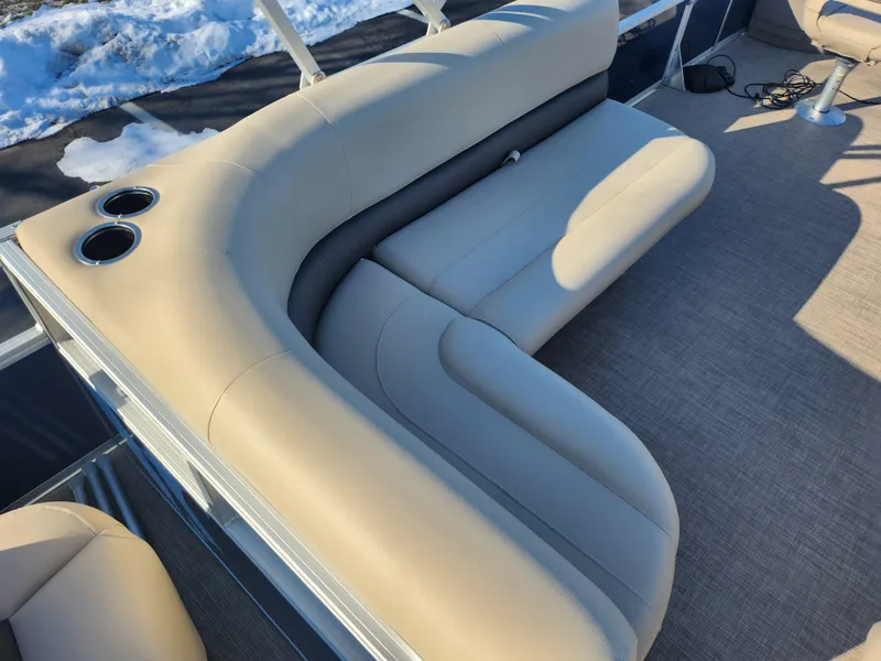 Slide: The Image of 2023 Sun Tracker Bass Buggy 18 DLX pontoon boat with beige seating and cup holders. - 17
