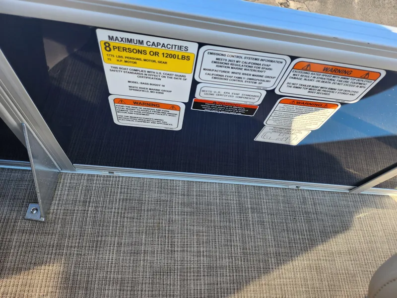 Slide: The Image of 2023 Sun Tracker Bass Buggy 18 DLX capacity labels, maximum 8 persons or 1200 lbs. - 19