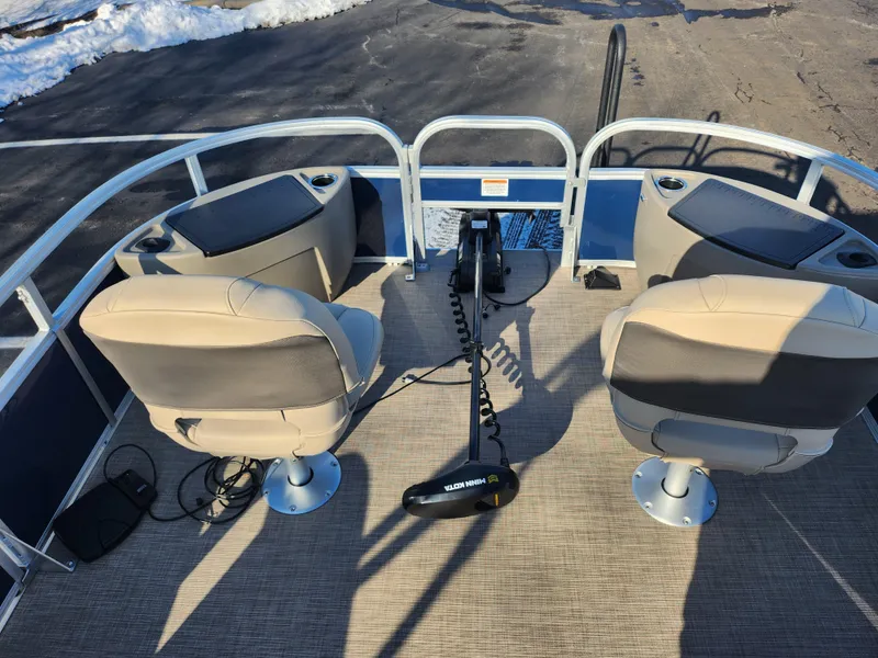 Slide: The Image of 2023 Sun Tracker Bass Buggy 18 DLX pontoon boat interior with two seats and a trolling motor. - 22
