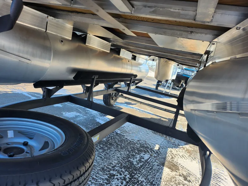 Slide: The Image of Underneath view of a 2023 Sun Tracker Bass Buggy 18 DLX pontoon boat on a trailer. - 7