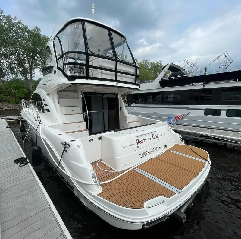Slide: The Image of 2005 Sea Ray 500 Sedan Bridge yacht docked, featuring spacious deck and sleek design. - 14