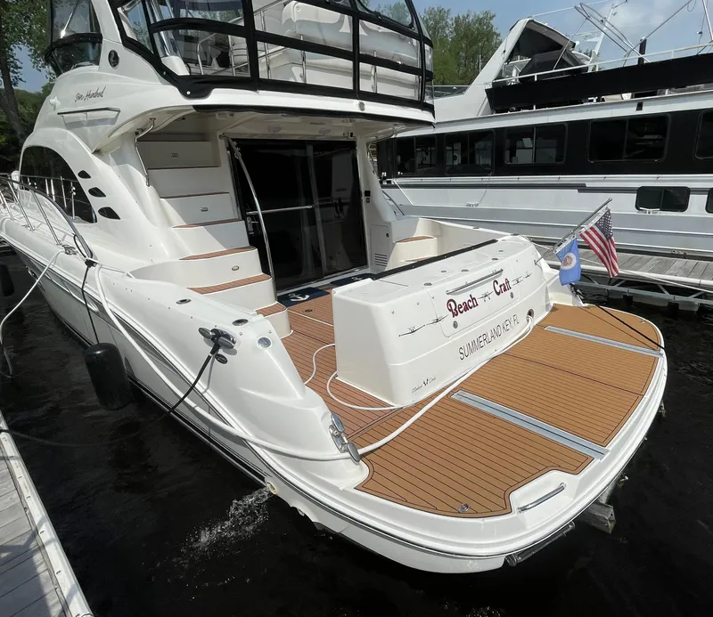 Slide: The Image of 2005 Sea Ray 500 Sedan Bridge yacht docked, featuring spacious deck and elegant design. - 15