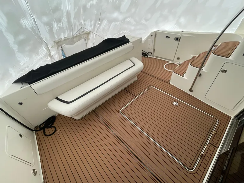 Slide: The Image of 2005 Sea Ray 500 Sedan Bridge deck with seating and teak flooring. - 16