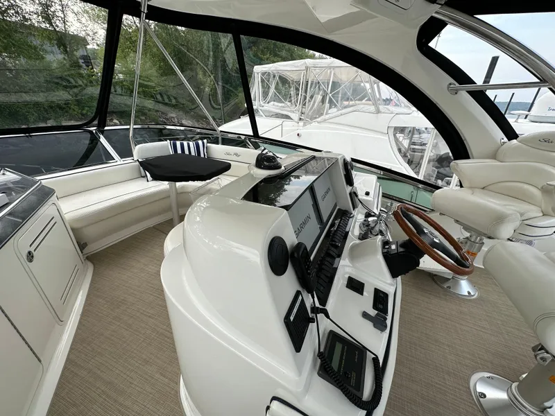 Slide: The Image of 2005 Sea Ray 500 Sedan Bridge helm with modern controls and panoramic windows. - 27