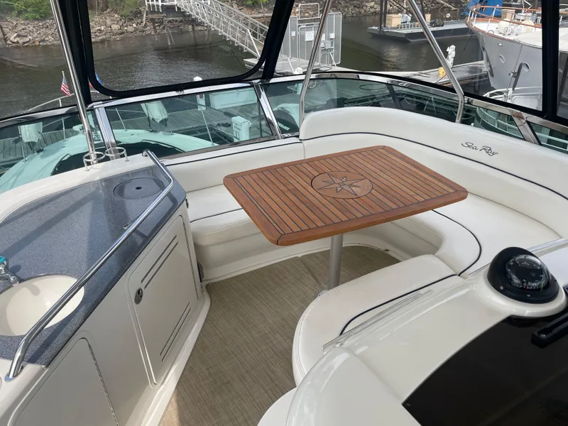 Slide: The Image of Luxurious 2005 Sea Ray 500 Sedan Bridge yacht interior with elegant seating and wooden table. - 28