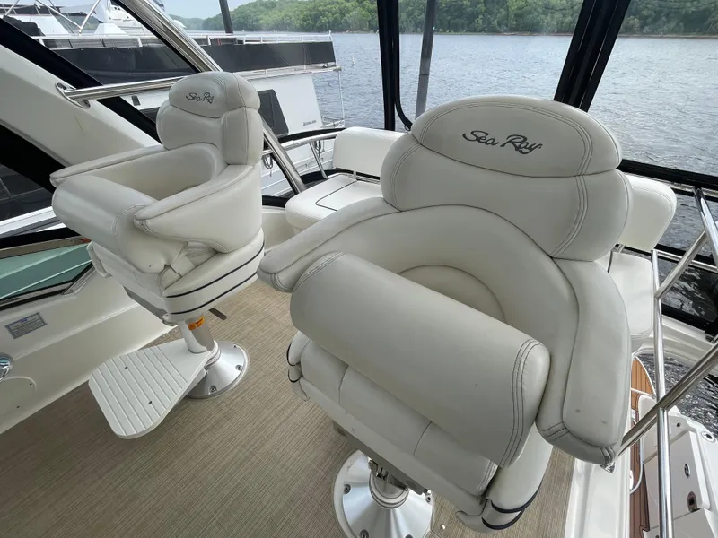 Slide: The Image of Luxurious 2005 Sea Ray 500 Sedan Bridge helm seats with waterfront view. - 33
