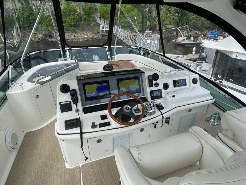Slide: The Image of 2005 Sea Ray 500 Sedan Bridge helm with dual screens and leather seating. - 35