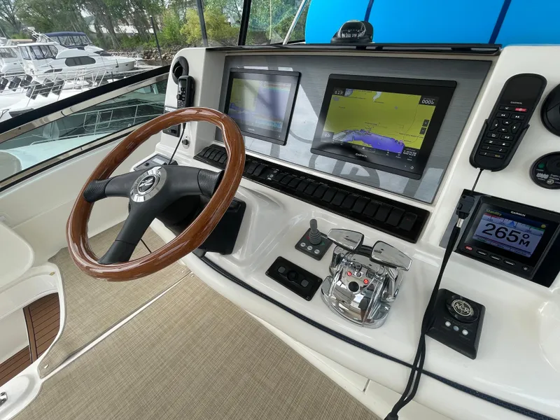 Slide: The Image of Helm of 2005 Sea Ray 500 Sedan Bridge with navigation screens and controls. - 37