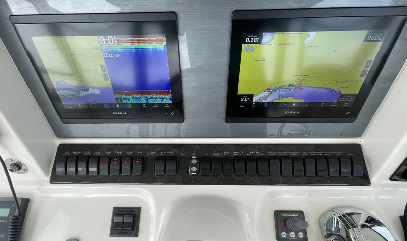 Slide: The Image of Control panel of a 2005 Sea Ray 500 Sedan Bridge with dual navigation screens. - 39