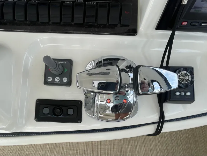 Slide: The Image of Control panel of a 2005 Sea Ray 500 Sedan Bridge yacht with chrome throttle levers. - 40