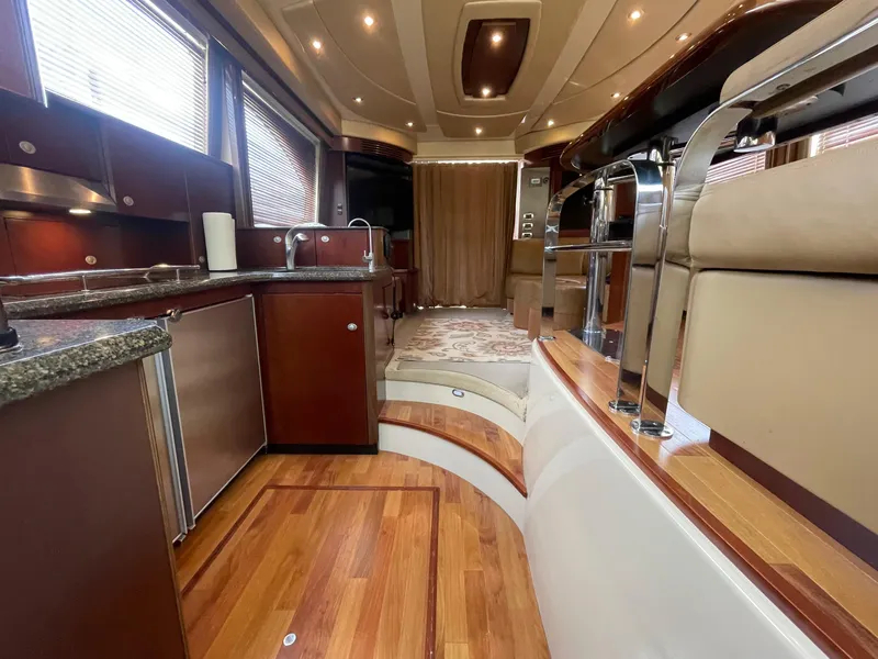Slide: The Image of Luxurious interior of a 2005 Sea Ray 500 Sedan Bridge yacht with modern kitchen and seating. - 44
