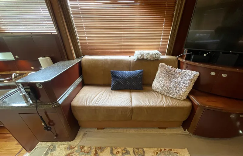 Slide: The Image of Luxurious interior of 2005 Sea Ray 500 Sedan Bridge with leather sofa and plush cushions. - 46