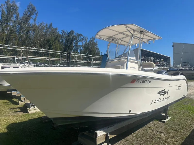 Slide: The Image of 2018 Cobia 220 Center Console boat on display outdoors. - 0