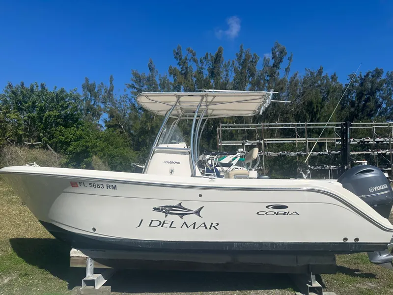 Slide: The Image of 2018 Cobia 220 Center Console boat on display, side view with Yamaha engine. - 1