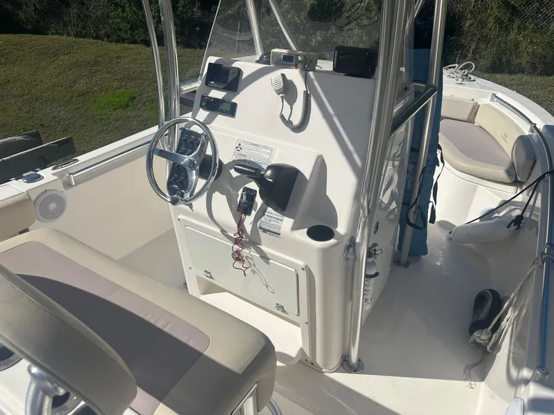 Slide: The Image of 2018 Cobia 220 Center Console boat interior with steering wheel and seating. - 14