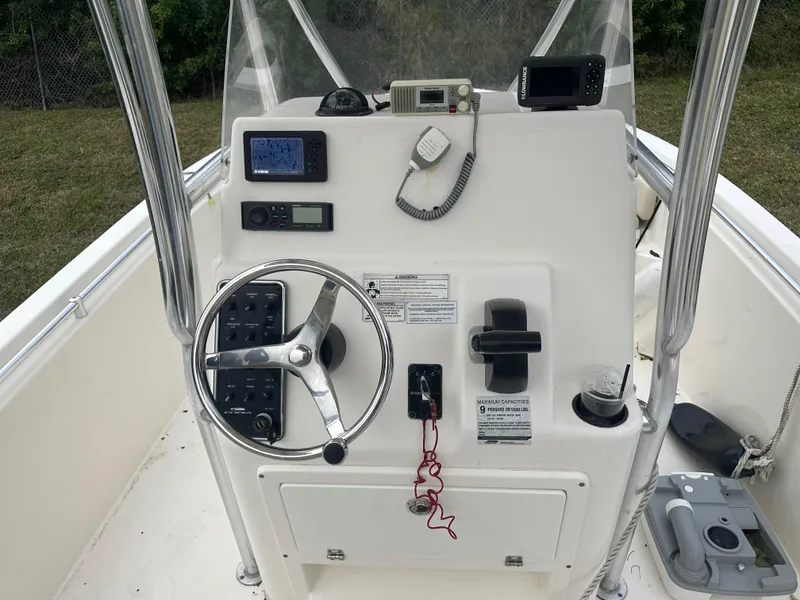 Slide: The Image of 2018 Cobia 220 Center Console boat dashboard with steering wheel and navigation equipment. - 15