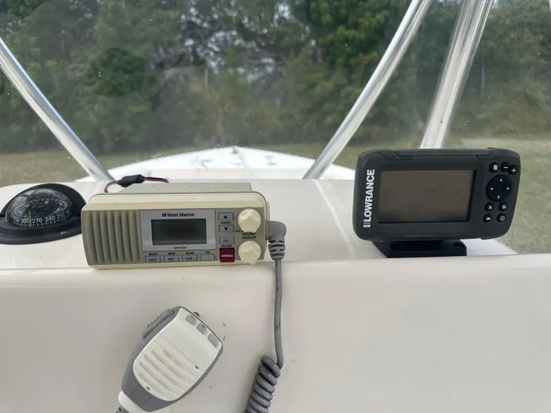 Slide: The Image of Cobia 220 Center Console 2018 dashboard with West Marine radio and Lowrance device. - 16