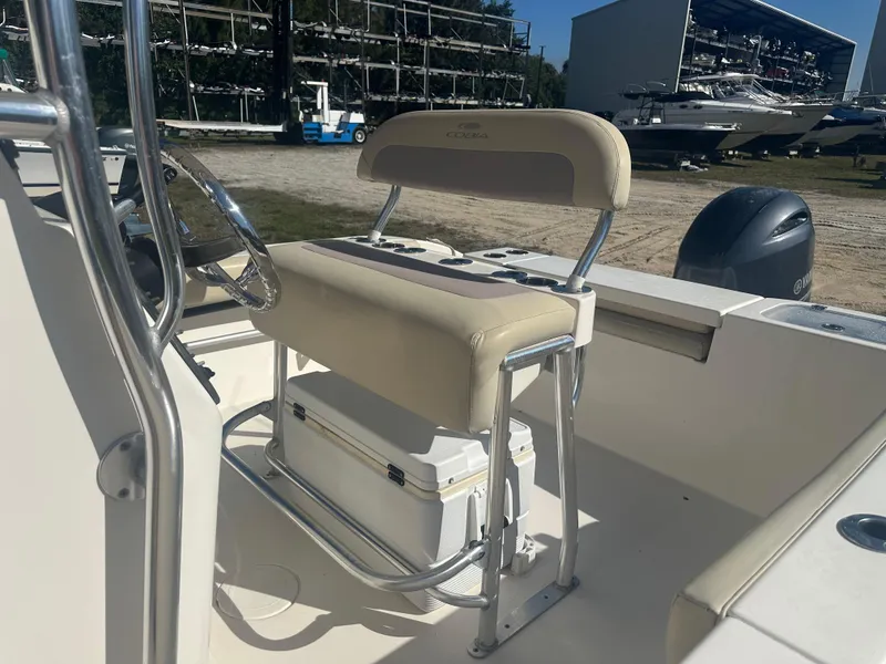 Slide: The Image of 2018 Cobia 220 Center Console boat interior with steering wheel and seating. - 17