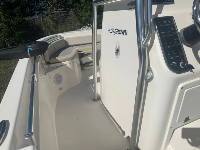 Slide: The Image of 2018 Cobia 220 Center Console boat interior with control panel and seating. - 18