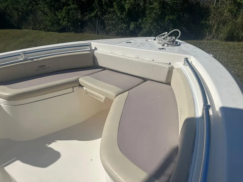 Slide: The Image of 2018 Cobia 220 Center Console boat with cushioned seating and rope on deck. - 19