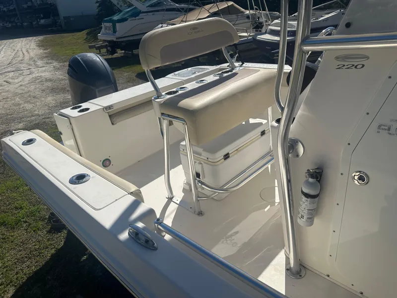 Slide: The Image of 2018 Cobia 220 Center Console boat interior with seating and console details. - 22