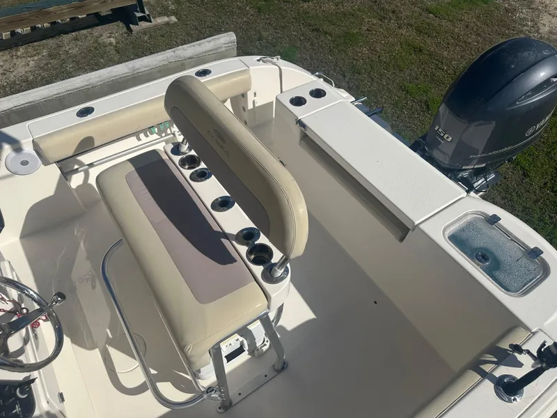 Slide: The Image of 2018 Cobia 220 Center Console boat interior with seating and Yamaha 150 engine. - 24