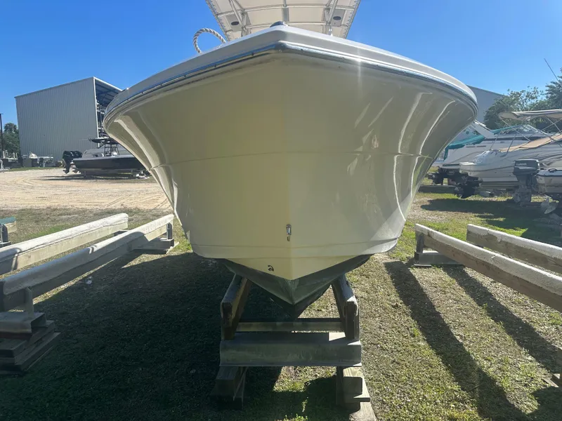 Slide: The Image of 2018 Cobia 220 Center Console boat on display in a sunny outdoor setting. - 7
