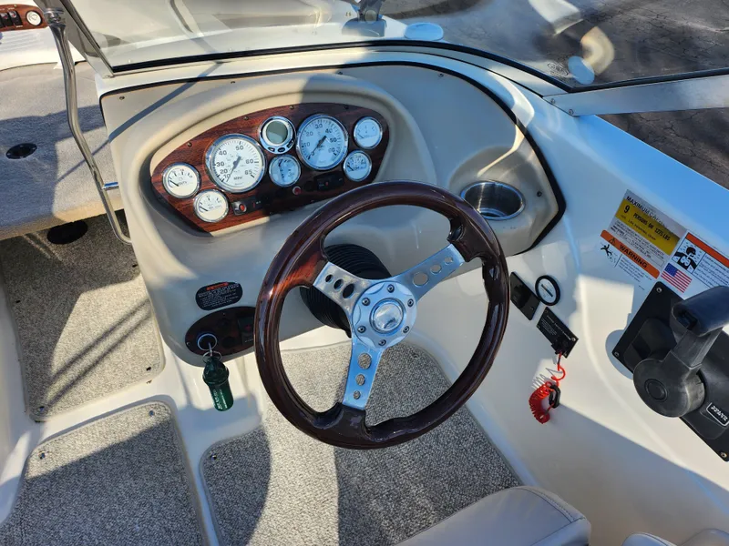 Slide: The Image of 2008 Glastron GT 205 Ski & Fish boat dashboard with steering wheel and gauges. - 14