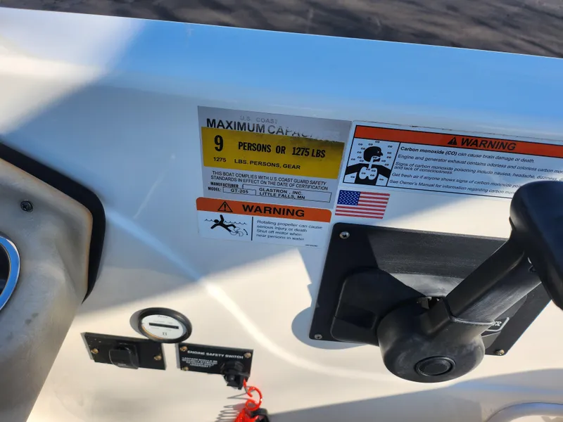 Slide: The Image of 2008 Glastron GT 205 Ski & Fish boat dashboard with capacity warning labels. - 15