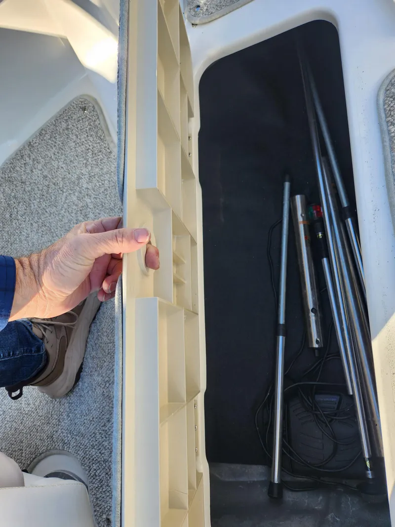 Slide: The Image of 2008 Glastron GT 205 Ski & Fish storage compartment with fishing rods. - 17